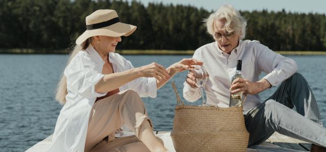 Two people having a picnic by a lake